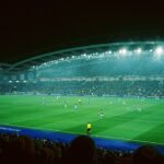 Soccer match in a packed stadium at night - football betting tips today