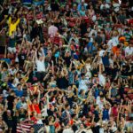 Football fans cheering in a packed stadium during a Betway Premiership title race match