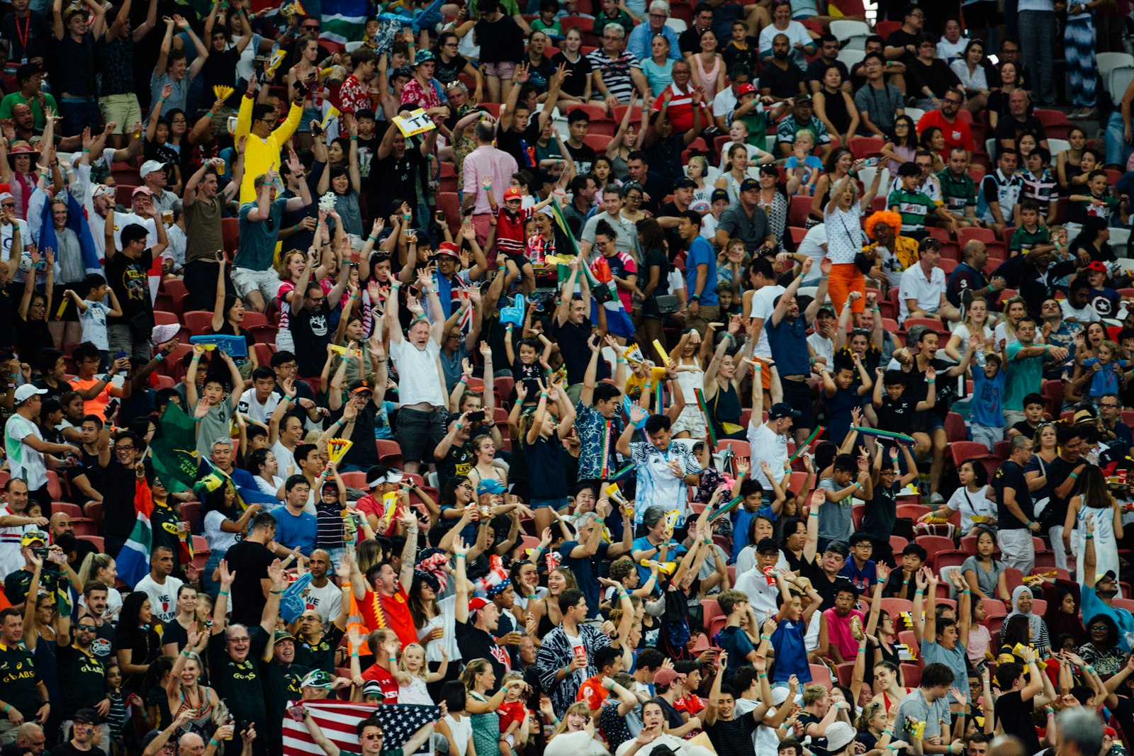 Football fans cheering in a packed stadium during a Betway Premiership title race match