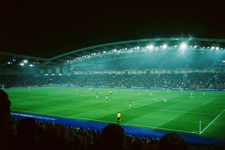 Stock photograph of a football match being played at night under stadium lights. It is not a photograph of Richards Bay, Mamelodi Sundowns, Princess Magogo Stadium or any Betway Premiership match.