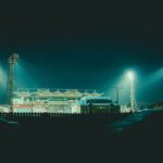 Stock photograph of stadium floodlights above a pitch on an evening kick-off. It is not a photograph of Durban City, AmaZulu, Chatsworth Stadium or any Betway Premiership match.