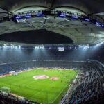 Champions League predictions tonight: a floodlit football stadium at night (stock photo, not a Champions League venue)