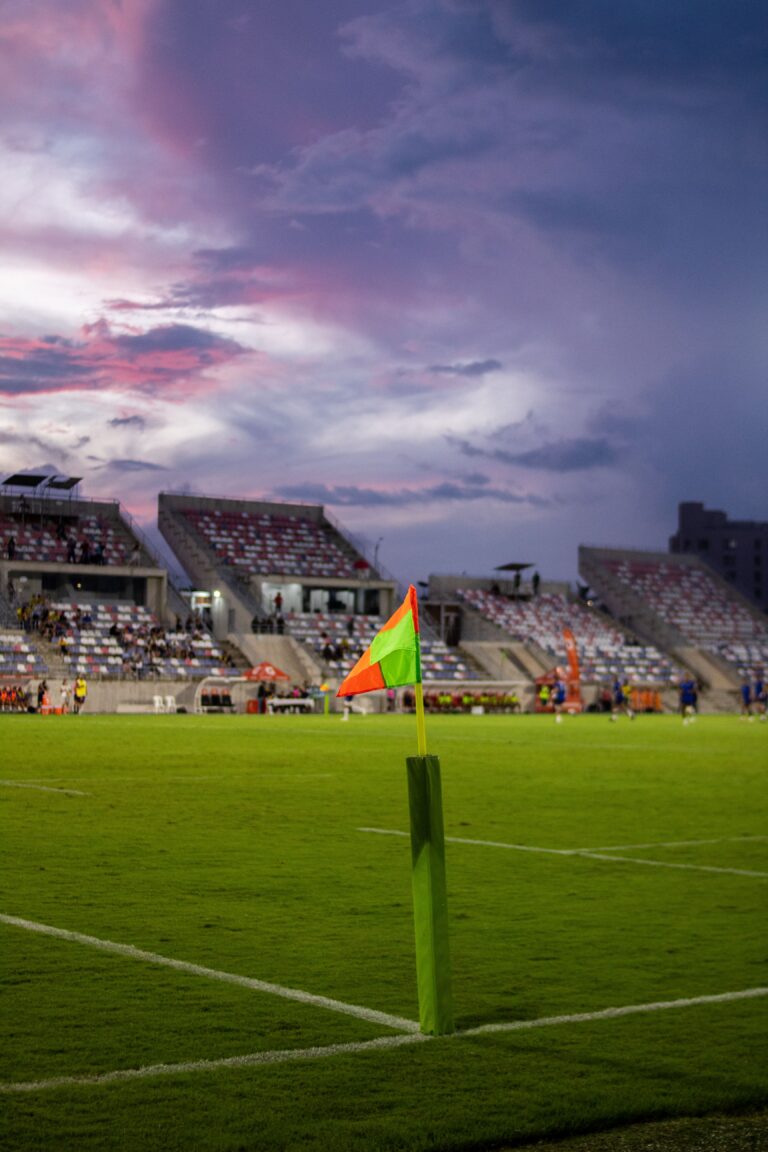 A corner flag in focus at a football ground under a dusk sky. This is a stock photograph and not Stamford Bridge.
